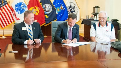 Georgia Southern Vice President for Enrollment Management Scot Lingrell and Vice President for University Advancement Trip Addison and The Landings Military Family Relief Fund Inc. Board of Directors Chairman Bob Longueira sign an agreement for a new scholarship fund designed for spouses of military service members.