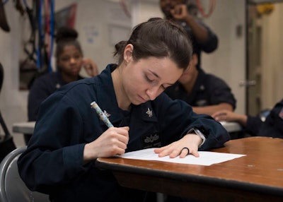 Operations Specialist 2nd Class Michelle Sanchez participates in an instructor-led Navy College Program for Afloat College Education class on board the dock landing ship Oak Hill.