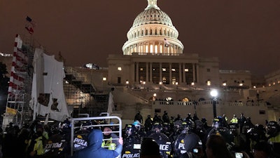 Riot Police And Protester Outside United States Capitol At Evening 20210106